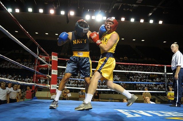 boxers in a ring trade blows to the head, which can contribute to a risk of CTE